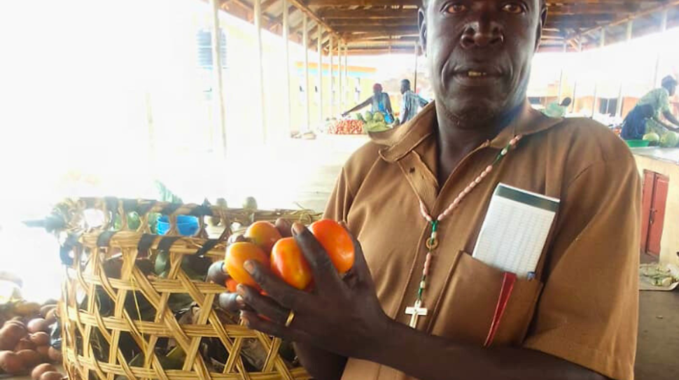 Mr. Omoolo Simon with-his vegetables