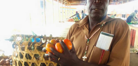 Mr. Omoolo Simon with-his vegetables Mr. Omoolo Simon with-his vegetables